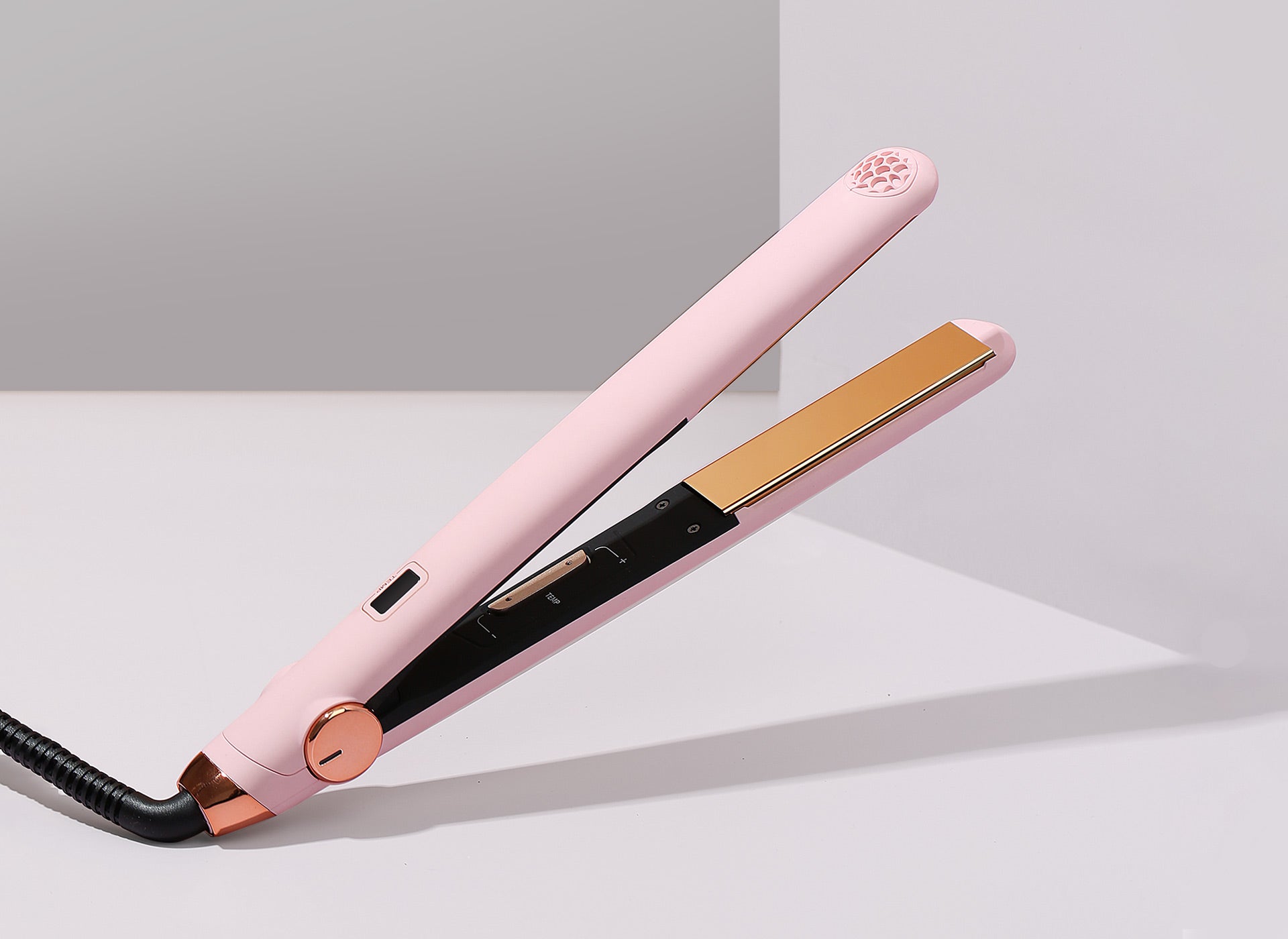 Elegant TYMO SWAY hair straightener with gold-plated plates, designed for creating sleek hairstyles with ease.