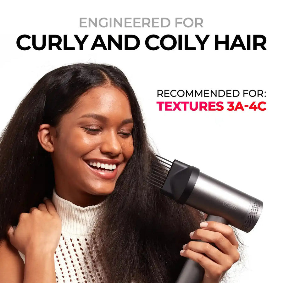 Smiling model using TYMO AIRHYPE comb nozzle as a straightener combo for curly and coily textures