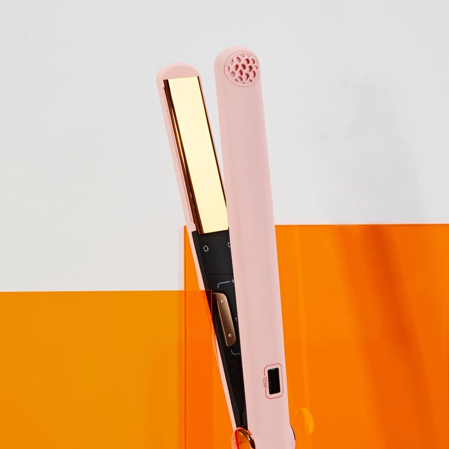 A close-up of the TYMO SWAY hair straightener flat iron showing its titanium flat iron with MCH technology.