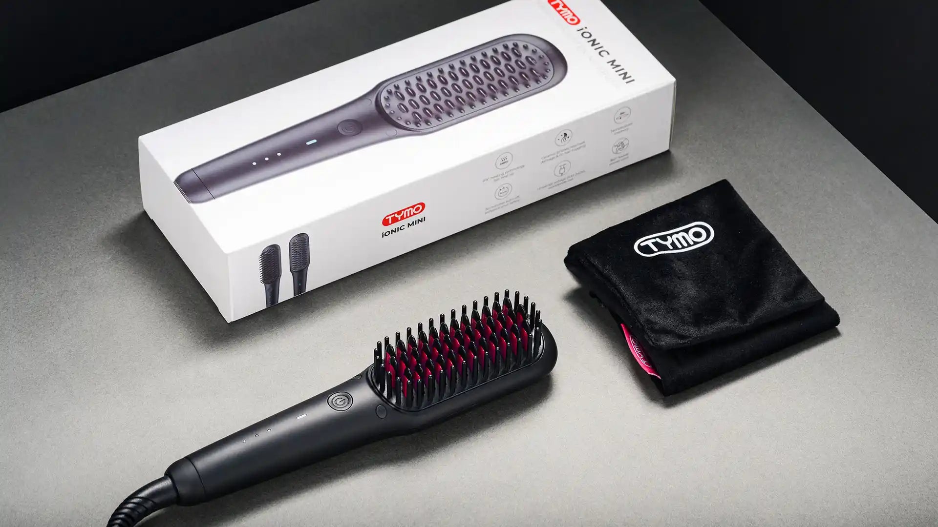 Compact design of TYMO iONIC MINI heated brush for straightening hair.