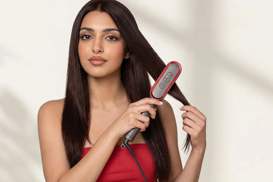 TYMO RING PLUS straightening brush being used to style and smooth long hair.