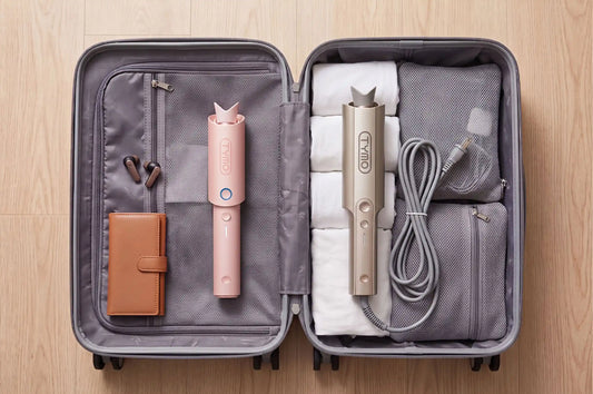 TYMO cordless and corded curling irons packed neatly inside a travel suitcase with accessories.