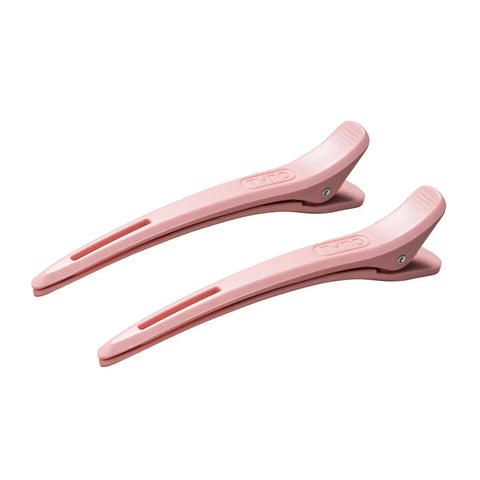 Pair of light pink TYMO styling hair clips with embossed logo and non-slip grip design displayed on a white background.
