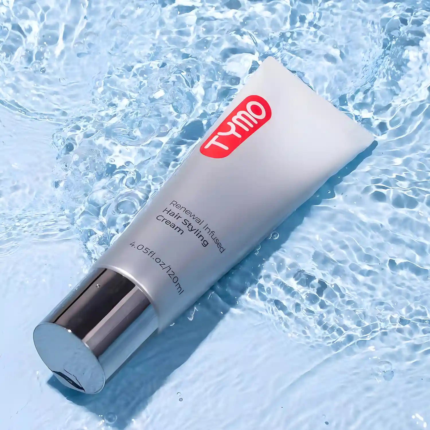 TYMO Leave-in Styling Treatment tube submerged in clear water, showcases its moisturizing and styling capabilities.