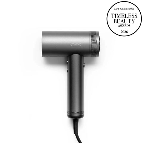Dark grey TYMO AIRHYPE high-speed hair dryer featured alongside a Katie Couric Media Timeless Beauty Awards 2026 badge on a white background.